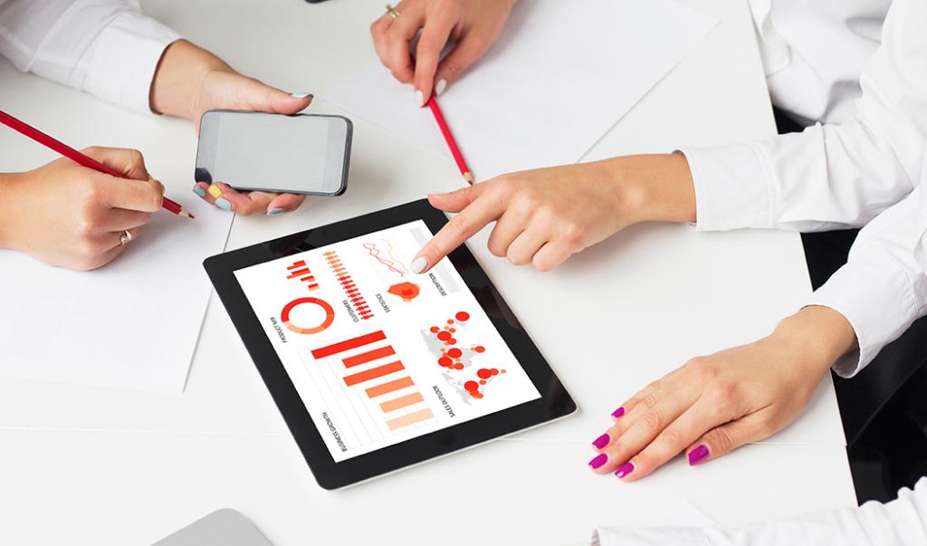 Group of people reviewing report on iPad