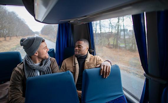 Two men travelling on bus