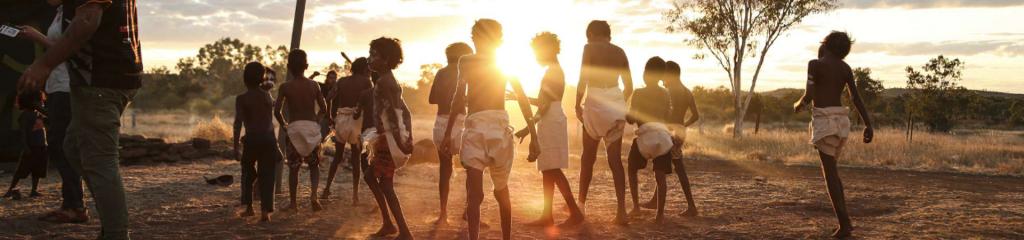 Group of children watching the sunset over the desert